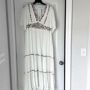 Brand new with tags- beautiful dress with embroidered flowers, open back w bow